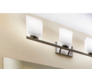 Bathroom with double sinks, cabinets, lighting, toilet, and shower-tub